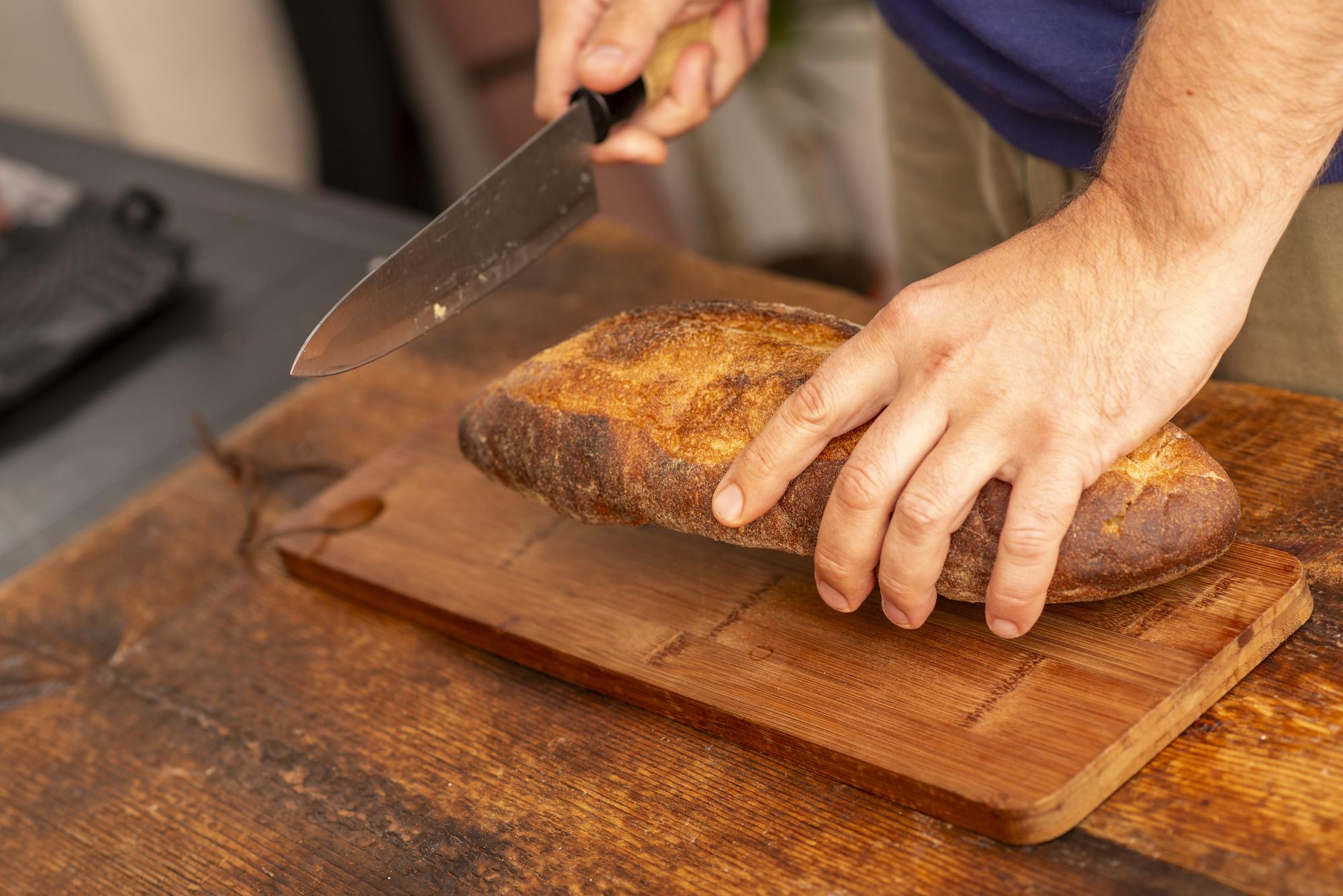 chef slicing artisan bread